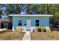 Charming single-story home with a light blue exterior, front yard, and a walkway leading to the front door at 769 53Rd N Ter, St Petersburg, FL 33703
