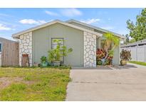 Charming single-story home with a well-maintained lawn and beautiful stone accents at 9112 Suffield Ct, Tampa, FL 33615