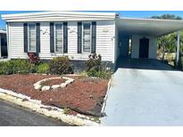 Charming single-story home with a covered carport and attractive landscaping at 9790 66Th N St # 80, Pinellas Park, FL 33782