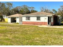 Charming single-story home with a separate garage and well-maintained lawn at 318 Banana St, Tarpon Springs, FL 34689