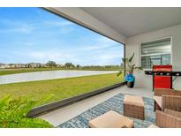 Relaxing lanai with lake view, stylish rug, and comfortable outdoor furniture, perfect for enjoying the serene scenery at 3504 Golden Wheat Ln, Plant City, FL 33565