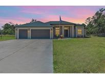 Charming single-story home featuring a spacious three-car garage and well-manicured lawn at 4323 Baynes Rd, North Port, FL 34288