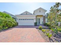 Charming single-Gathering home with a brick driveway and manicured landscaping at 5548 Silver Sun Dr, Apollo Beach, FL 33572