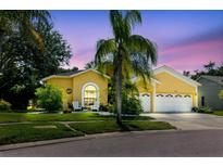 Beautiful home with a well-kept yard, two-car garage, and welcoming front seating area, perfect for relaxing at 11209 Pocket Brook Dr, Tampa, FL 33635
