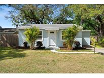 Charming single-story home featuring a well-maintained lawn and inviting front entrance, enhanced by lush landscaping at 1276 Bertland Way, Clearwater, FL 33755