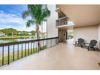 Relaxing balcony with black metal railings and serene water views with two outdoor chairs for enjoying peaceful moments at 1806 Mariner Dr # 112, Tarpon Springs, FL 34689