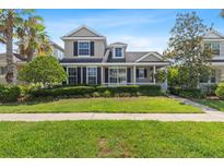 Charming two-story home featuring well-manicured landscaping, a covered porch, and a welcoming facade at 20113 Bending Creek Pl, Tampa, FL 33647