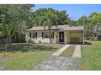 Charming single-story home with a cozy carport and well-maintained front yard, enhanced by a palm tree at 249 41St Ne Ave, St Petersburg, FL 33703