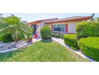 Charming single-story home features manicured landscaping, decorative stone, and lush green grass at 2509 Locksley St # 237, Sun City Center, FL 33573
