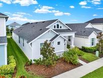 Well-maintained one-story home with a neatly landscaped yard and a clean, modern facade at 28680 Cozy Creek Dr, Wesley Chapel, FL 33543