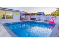 Beautiful pool area with gazebo, lounge chairs, flamingo float and well-maintained patio, perfect for outdoor entertaining at 4644 Bay Crest Dr, Tampa, FL 33615