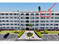 Well-maintained condo complex featuring lush landscaping, mature palm trees, and ample parking at 5501 80Th N St # 509, St Petersburg, FL 33709