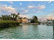 Waterfront home with lush landscaping and private dock in a tranquil setting at 712 Sunset Cv, Madeira Beach, FL 33708