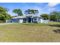 Charming single-story home featuring a well-maintained lawn and a light blue exterior at 8604 Vicksburg Rd, Spring Hill, FL 34608