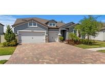 Charming single-Gathering home with a three car garage and brick paver driveway, situated in a well-kept neighborhood at 19204 Briarbrook Dr, Tampa, FL 33647