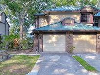 Inviting townhome featuring a well-manicured lawn and convenient two-car garage at 2663 Sequoia Ter # 2663, Palm Harbor, FL 34683