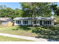 Charming single-story home boasts a lush green lawn, classic shutters, and a welcoming entrance at 315 Oakwood Blvd, Oldsmar, FL 34677