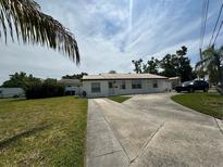 Charming single-story home with a well-manicured lawn and a long driveway at 4031 Bay Ne St, St Petersburg, FL 33703