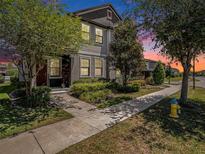 Charming two-story home with landscaped yard and inviting walkway at dusk at 5714 Colony Glen Rd, Lithia, FL 33547