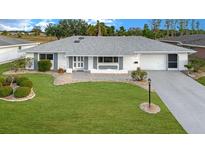 Charming single-story home boasts a well-manicured lawn, delightful landscaping, and a driveway leading to an attached garage at 646 Allegheny Dr, Sun City Center, FL 33573