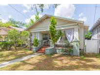 Charming single-story home with a welcoming front porch and lush landscaping at 1008 E 25Th Ave, Tampa, FL 33605