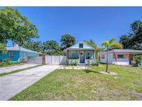 Charming blue cottage with a well-manicured front yard and inviting curb appeal at 1240 Georgia Ave, Dunedin, FL 34698