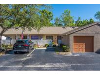 Charming exterior featuring well-manicured landscaping, front garage, and a private courtyard at 3135 Charter Club Dr # G, Tarpon Springs, FL 34688