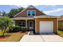 Charming two-story home featuring a well-maintained yard and an attached one car garage at 6616 Northhaven Ct, Riverview, FL 33578