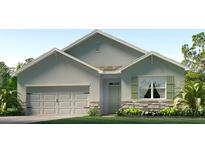 Charming single-Gathering home featuring a two-car garage, stone accents, and well-manicured lawn at 3525 Thistle Bank Ct, Plant City, FL 33565