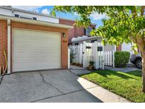 Charming brick home with attached garage and landscaped walkway to gated entrance at 404 Danube Ave, Tampa, FL 33606