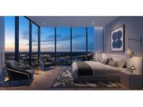 Beautiful main bedroom featuring floor to ceiling windows showcasing city skyline views at 1101 E Jackson St # 3805, Tampa, FL 33602