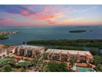 Beautiful coastal condos featuring red tile roofs, tropical landscaping, and stunning bay views at sunset at 1695 Pinellas Bayway S # E6, St Petersburg, FL 33715