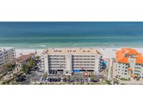 Coastal condominium building with beach access and well-maintained parking at 19418 Gulf Blvd # 507, Indian Shores, FL 33785
