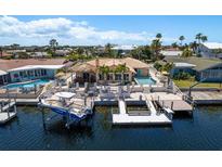 Waterfront home with boat dock, tiki bar, pool, and patio area perfect for outdoor entertaining and enjoying the coastal lifestyle at 3235 Seaway Dr, New Port Richey, FL 34652