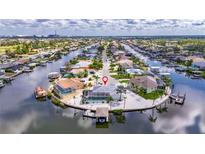 Stunning aerial view of waterfront property in a charming neighborhood with private boat dock and mature landscaping at 927 Golf Island Dr, Apollo Beach, FL 33572