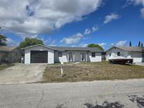 Cozy single-story home with a separate garage and well-lit entrance, perfect for comfortable living at 11215 Yewtree Ave, Port Richey, FL 34668