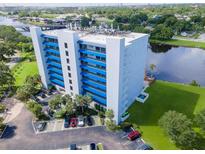 Modern condo building with private parking, river access, and lush landscaping creates an inviting waterfront living experience at 2780 N Riverside Dr # 802, Tampa, FL 33602