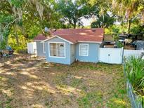 Charming single-Gathering home with a new roof, fenced yard and mature trees at 3212 E Henry Ave, Tampa, FL 33610
