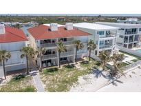 Stunning beachfront property featuring multiple balconies and lush landscaping, offering serene coastal living at 36 Gulf Blvd # 3, Indian Rocks Beach, FL 33785