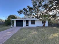 Charming single-story home featuring a covered entrance and brick driveway at 4623 Irene Loop, New Port Richey, FL 34652