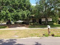 Charming single-story home featuring mature trees, lush landscaping, and a welcoming front lawn at 601 Park Blvd, Oldsmar, FL 34677