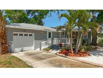 Charming single-story home with a well-manicured front yard and an attached one-car garage at 6609 Dartmouth N Ave, St Petersburg, FL 33710