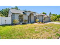 Charming single-story home with a well-maintained lawn and inviting front entrance at 7080 Nicole Ln, Largo, FL 33771
