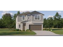 Charming two-story home features a two-car garage, well-manicured lawn and traditional architectural details at 9451 Raised Tulip Ln, Land O Lakes, FL 34637