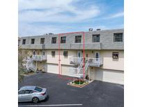 Charming condo with staircase leading to a cozy balcony and attached garages at 12485 2Nd E St # C103, Treasure Island, FL 33706
