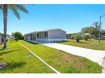 Charming home with a covered carport, well-maintained lawn, and a concrete driveway at 14383 Dehaven Ave, Brooksville, FL 34613