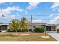 Charming single-story home featuring manicured landscaping and a welcoming facade at 1528 Chevy Chase Dr, Sun City Center, FL 33573