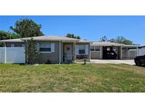 Charming single-story brick home featuring a well-maintained lawn and an attached carport at 2505 Minnehaha, Tampa, FL 33614