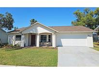 Charming single-story home with a well-maintained lawn and an attached two-car garage at 4505 Alligator Dr, New Port Richey, FL 34653