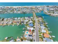Waterfront property with a pool and boat dock, located on a canal near the beach at 455 115Th Ave, Treasure Island, FL 33706